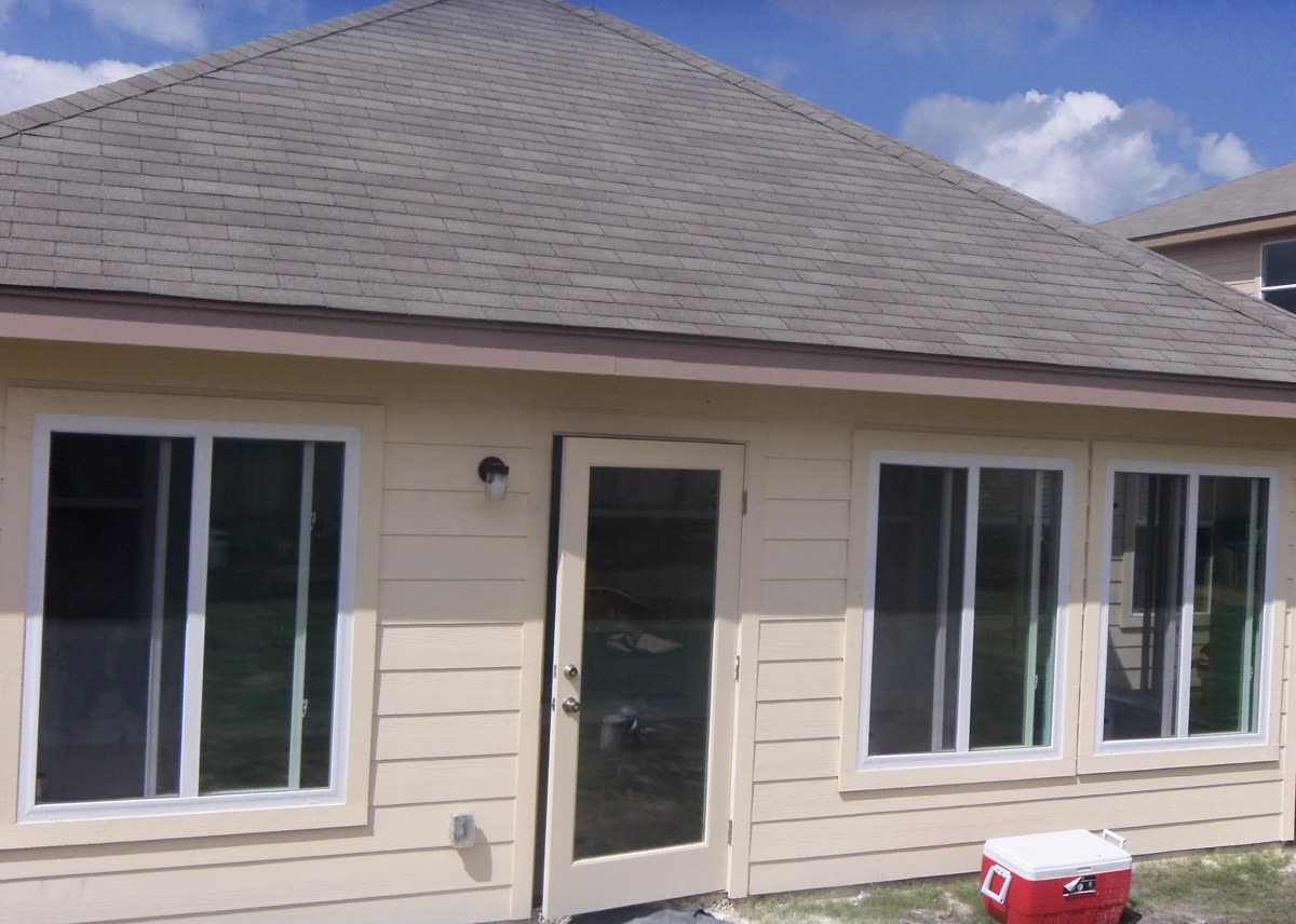 Finished sunroom addition exterior with French door and matching trim