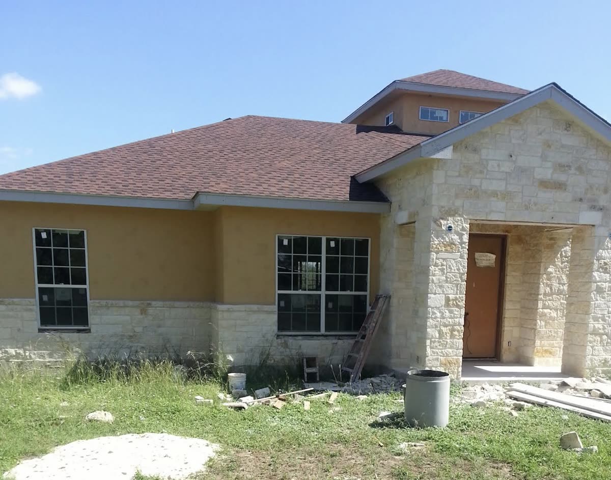 Stone and stucco home addition under construction
