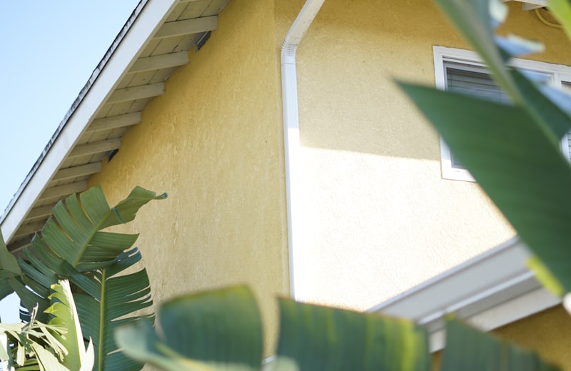 Seamless white gutter on a yellow stucco home