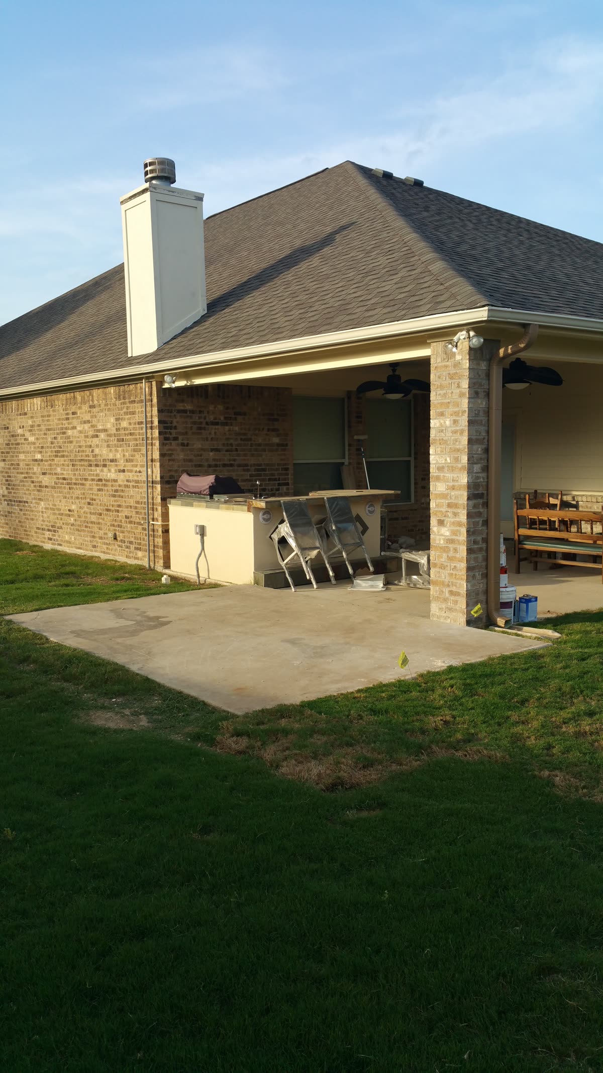 Covered patio with an outdoor kitchen counter and bar seating